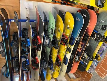 Row of colorful snowboards arranged side by side.