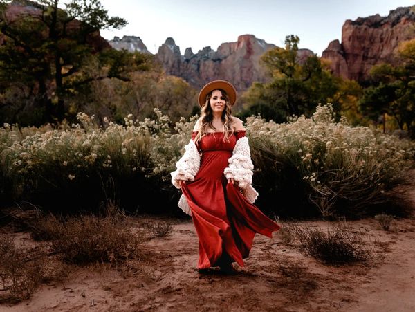 Zion National Park backdrop, Reiki practitioner portrait, long rust colored dress.