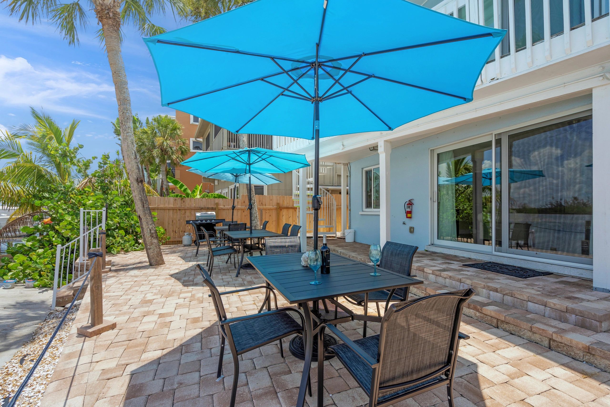A patio area with outdoor furniture and umbrellas