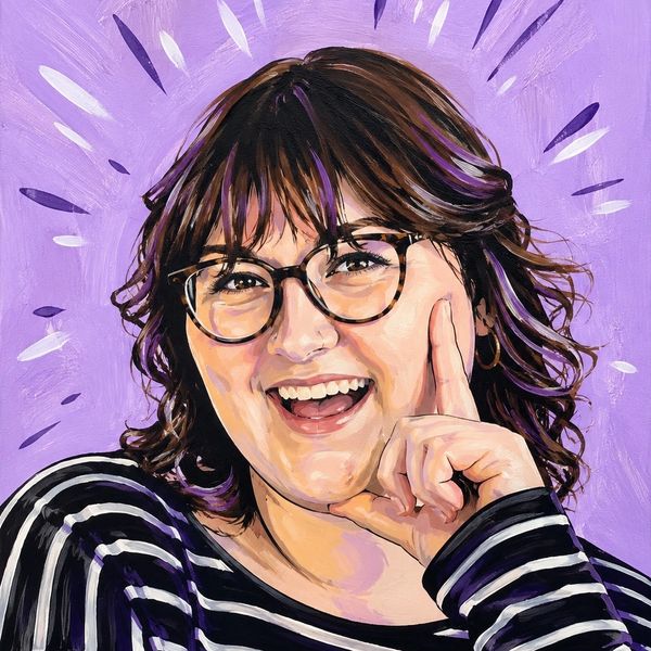 Portrait of a smiling woman with glasses and striped shirt.