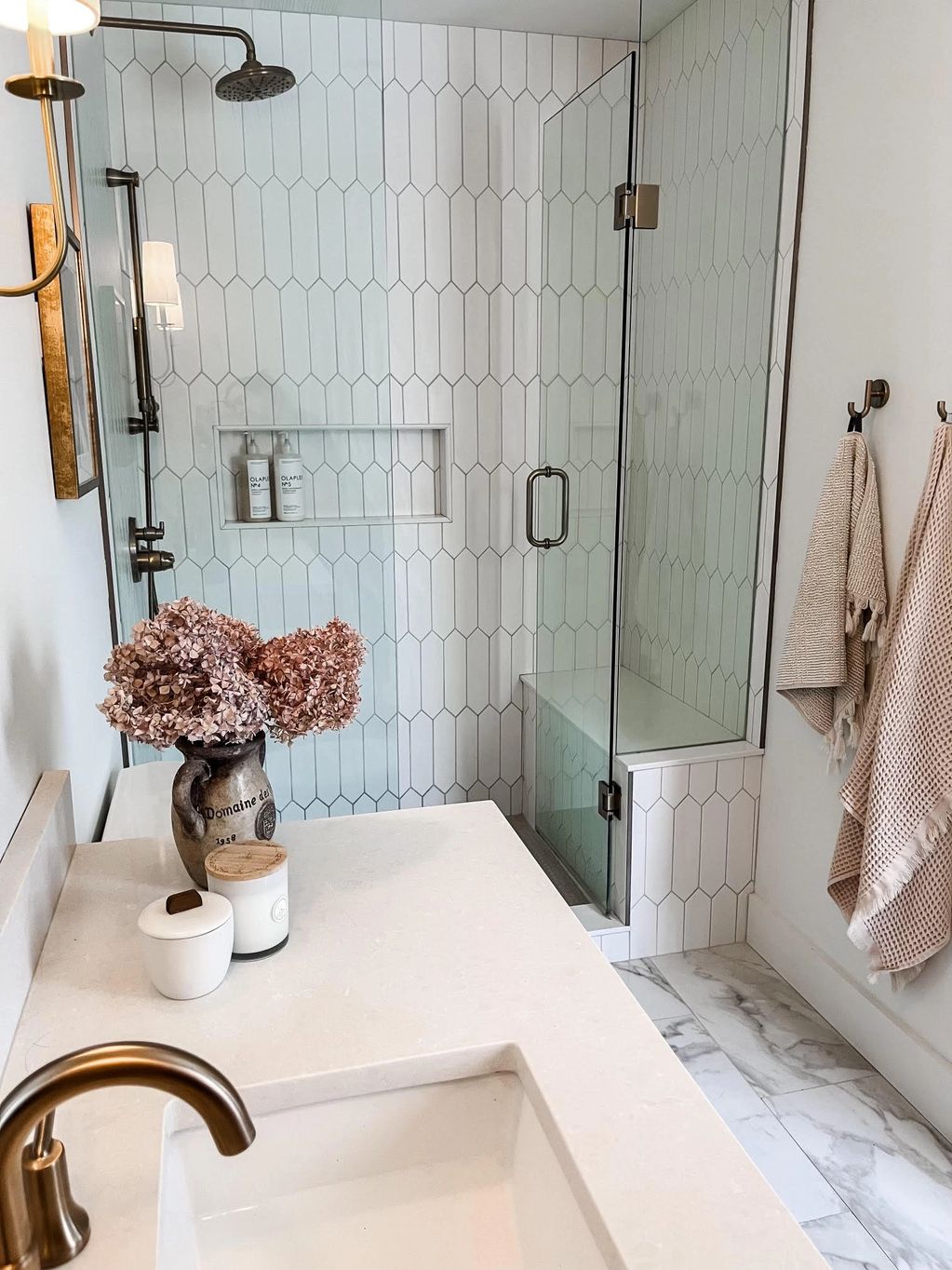 washroom renovation. Tile shower with bench, niche and seamless glass. 