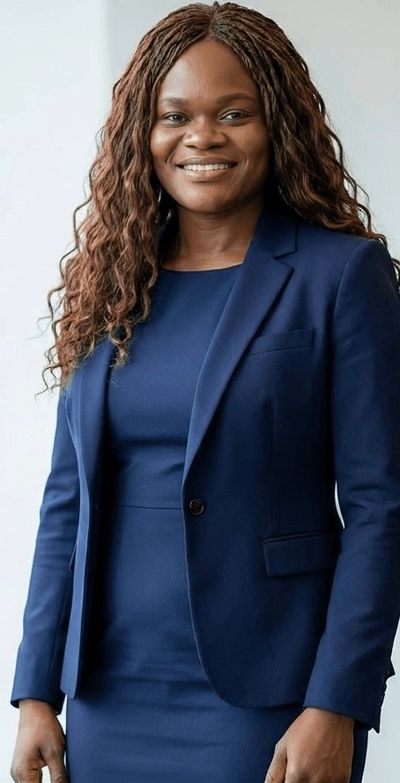 Professional woman in a navy blue suit smiling confidently.