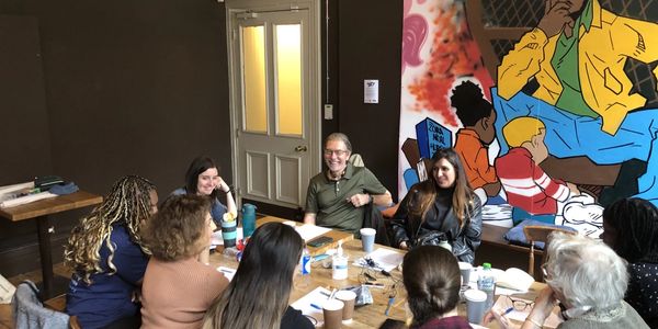 Visually Impaired Partnership participants sitting around a table having a discussion 