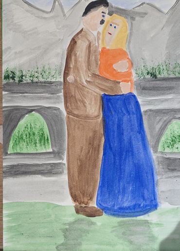 A couple embracing outdoors beside a stone railing.