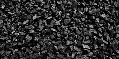 Close-up of shiny black coal pieces tightly packed together.