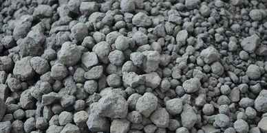Pile of gray, irregularly shaped gravel or small rocks.