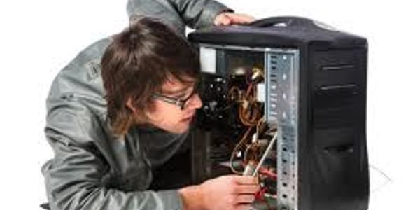 A man repairing the inside of a desktop computer.