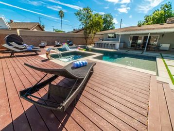 reclining chairs by a pool at a California sober living home