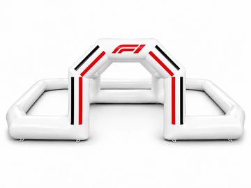 Inflatable white archway with F1 logo and red, black stripes.
