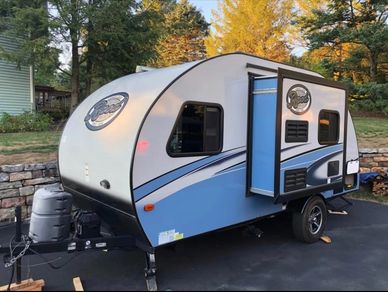 The R-Pod sleeps 4 and has a wet bathroom, kitchen, heat/AC, and tons of storage.