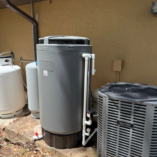 Outdoor water heater and air conditioning unit setup.