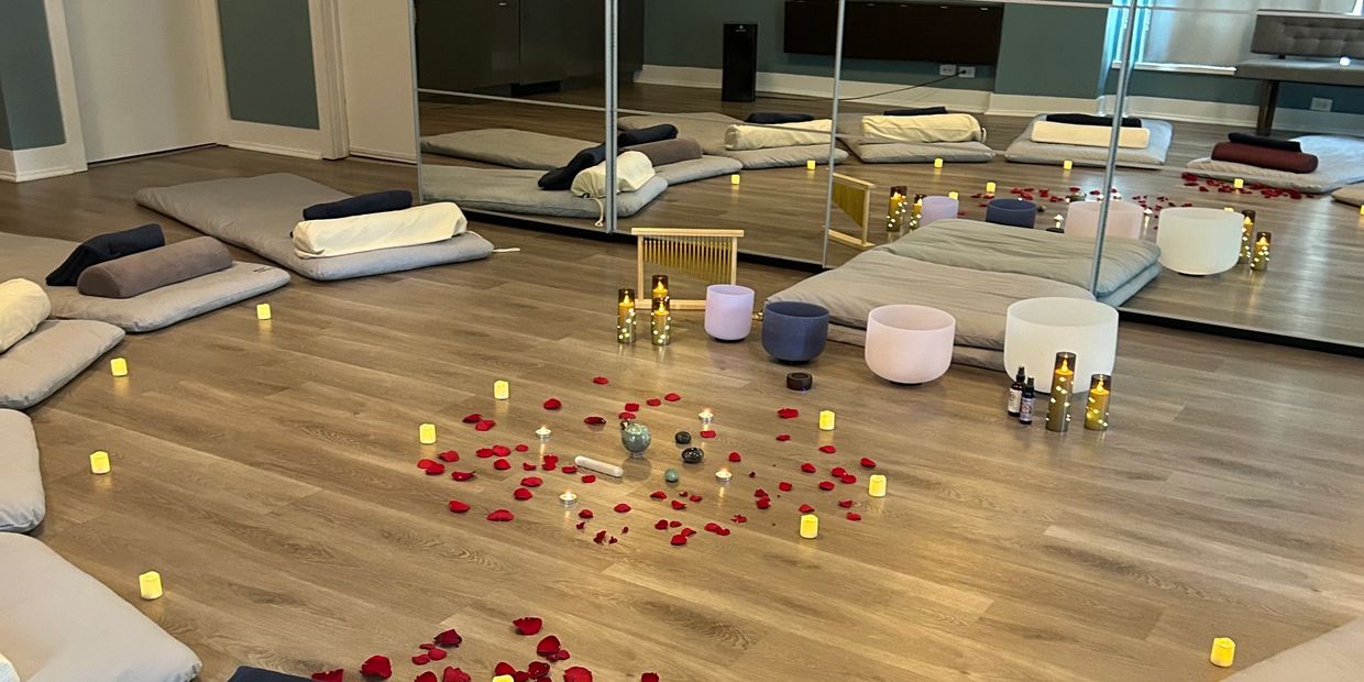 Crystal sound bowls and candles prepared for a private event in Chicago wellness studio.
