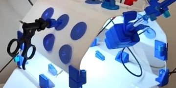 A medical robotic device with instruments and suction cups.