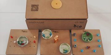Handmade cardboard dioramas with miniature scenes and a cardboard box.