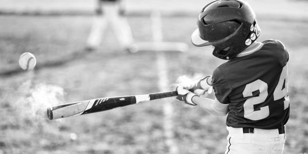 Baseball player hitting a ball with a bat.