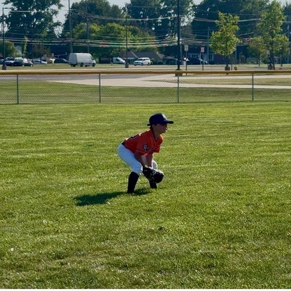 Young baseball player ready in the field.