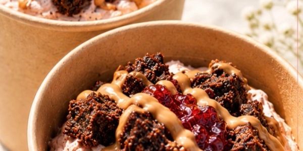 Dessert bowls with chocolate, peanut butter drizzle, and berry jam.
