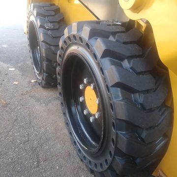 Skid steer solid tire, solid skid steert ire, solid tire and wheel assembly.  skid steer tires