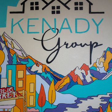 Colorful mural featuring mountains, buildings, and the text 'Kenady Group'.