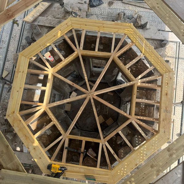 Wooden octagonal frame from above at a construction site.