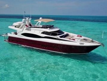 A luxury yacht anchored in clear turquoise water.