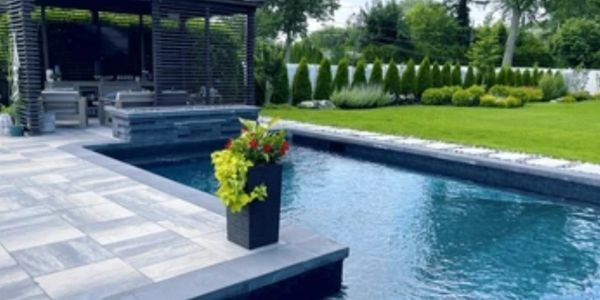 Modern backyard with a sleek pool and patio area.