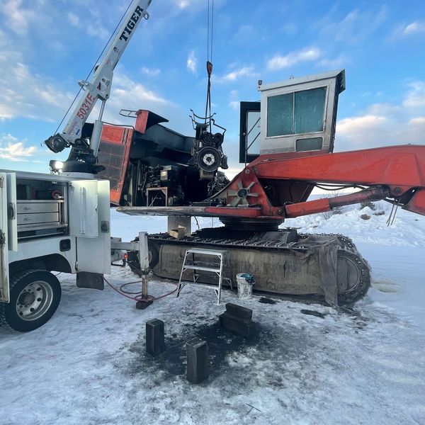 Installing an engine into a Madill 3800 log loader after re-sealing the oil pan and front cover.