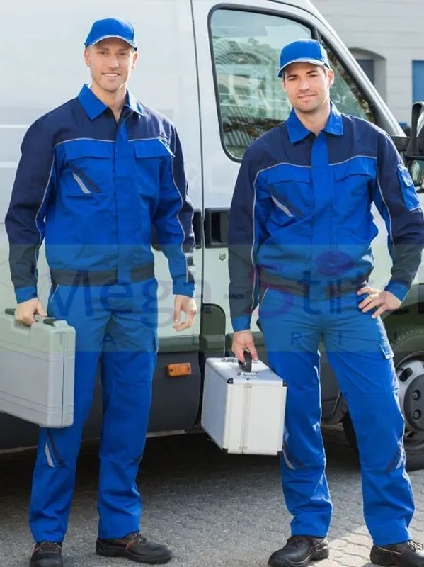 Two expert plumbers wearing blue that are ready to work