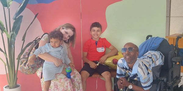 Family enjoying Easter celebration at GWC with colorful backdrop.