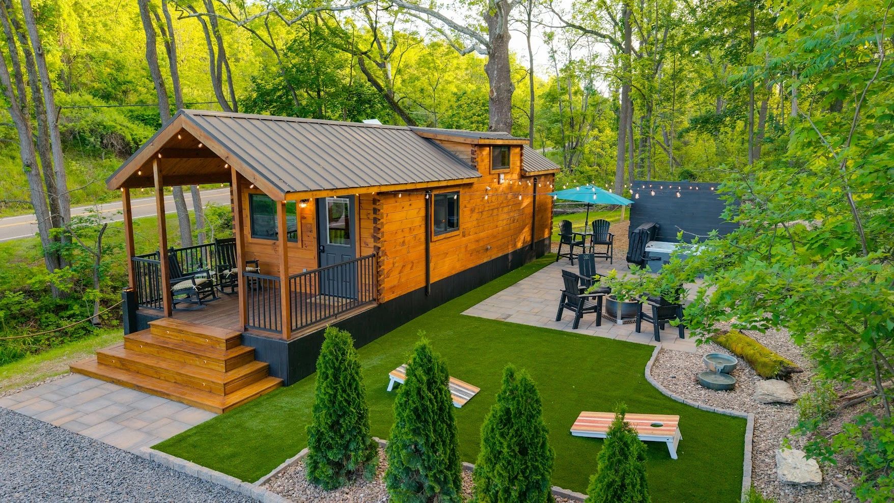 Stack of books next to pencils in a holder and a camera.