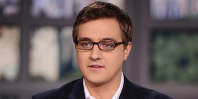 Man wearing glasses speaking.