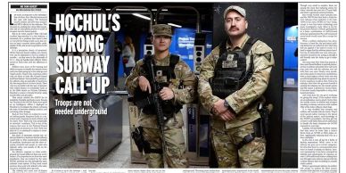 Two uniformed troops stand in a subway station with headline about wrong subway call-up.