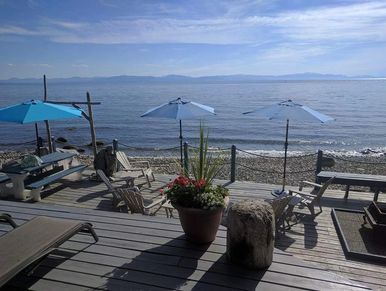 Beach deck with umbrellas with ocean shoreline and horizon