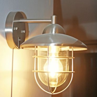 Wall-mounted industrial-style light fixture with metal cage.