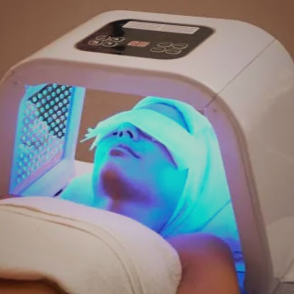 LED light therapy machine used on woman