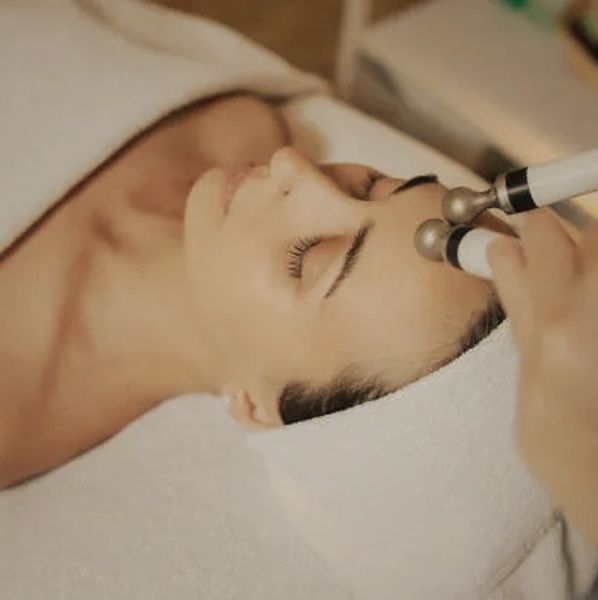 microcurrent facial on woman using wands