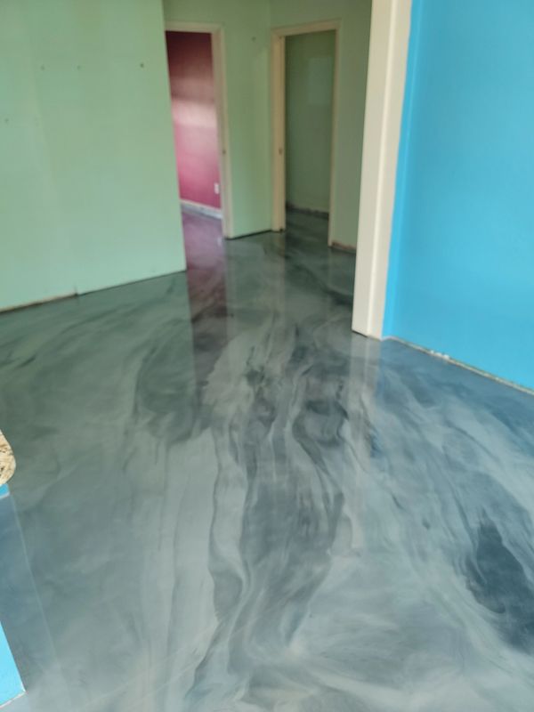 Shiny marbled floor with colorful walls in a hallway.