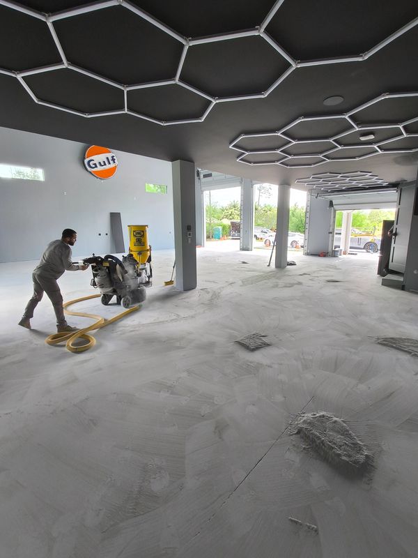 Metallic epoxy floor start up installation, showing the concrete grinding process.