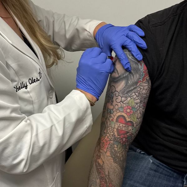 Nurse practitioner administering vitamin injection at Vitality Wellness Center