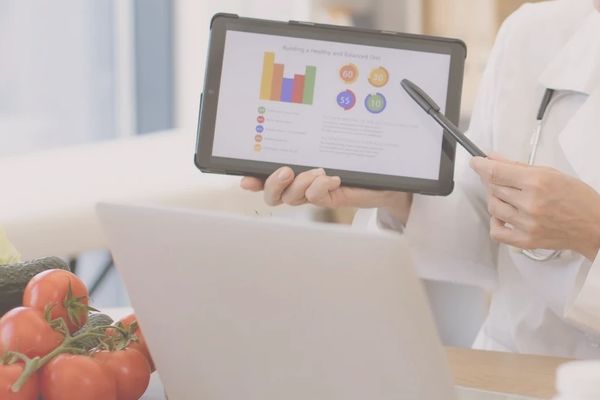 Vitality Wellness nurse practitioner completing health coaching with a patient. 