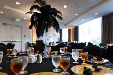 Elegant banquet table with black feather centerpiece.