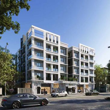 Modern multi-story residential building with cars parked in front on a sunny day.
