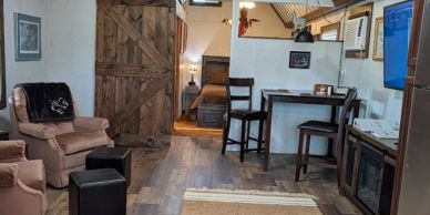 Cozy living room with rustic wooden door and seating.