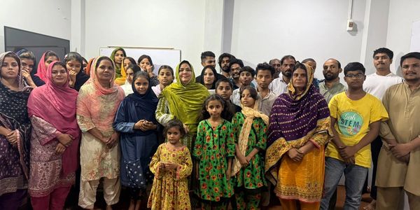 A diverse group of people posing together indoors for a photo.