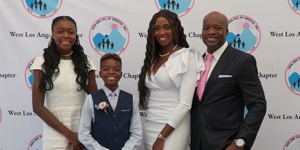 A family dressed elegantly at an event.