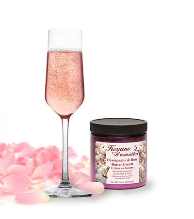 Champagne and rose butter cream with pink petals and a champagne flute.