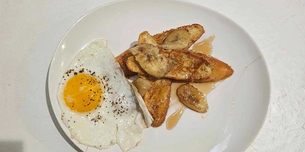 Bananas Foster French toast with a fried egg