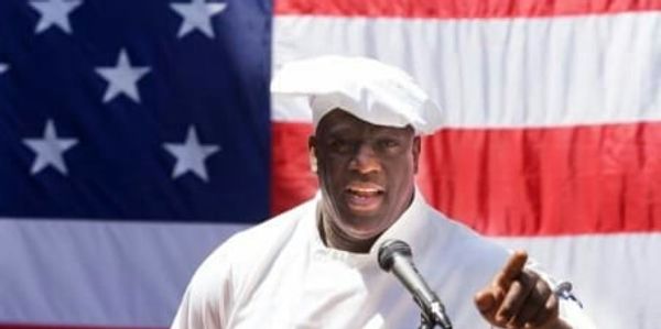 Chef standing in front of American Flag