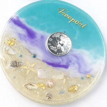 Decorative resin art resembling a beach with shells and starfish.