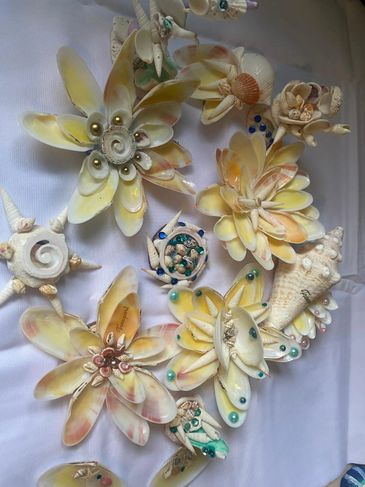Intricate floral designs crafted from seashells and pearls.